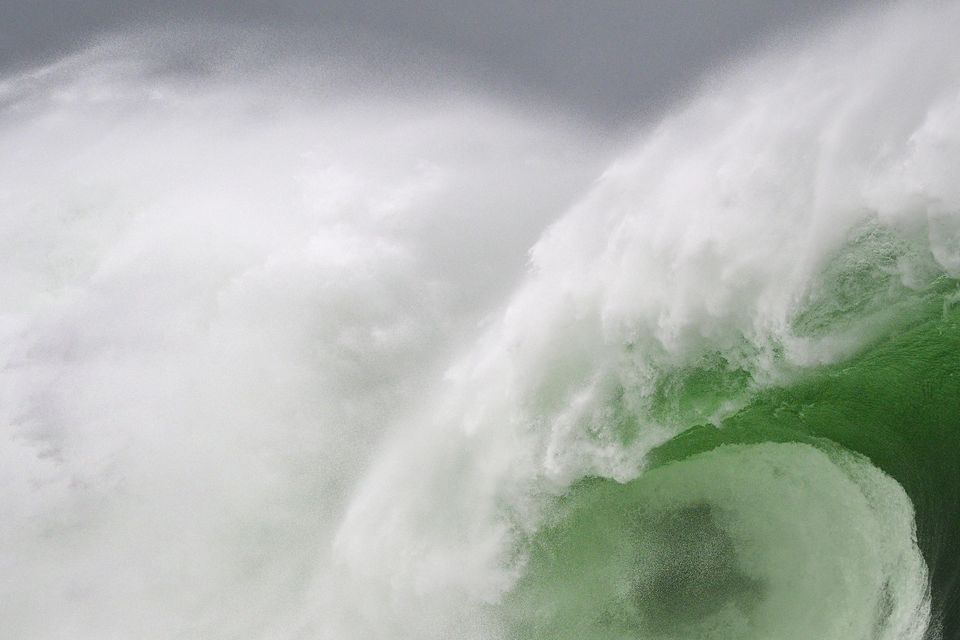 A surfer catches a massive swell in Mullaghmore, Co Sligo. Photo: Gary McCall/Red Bull Content Pool